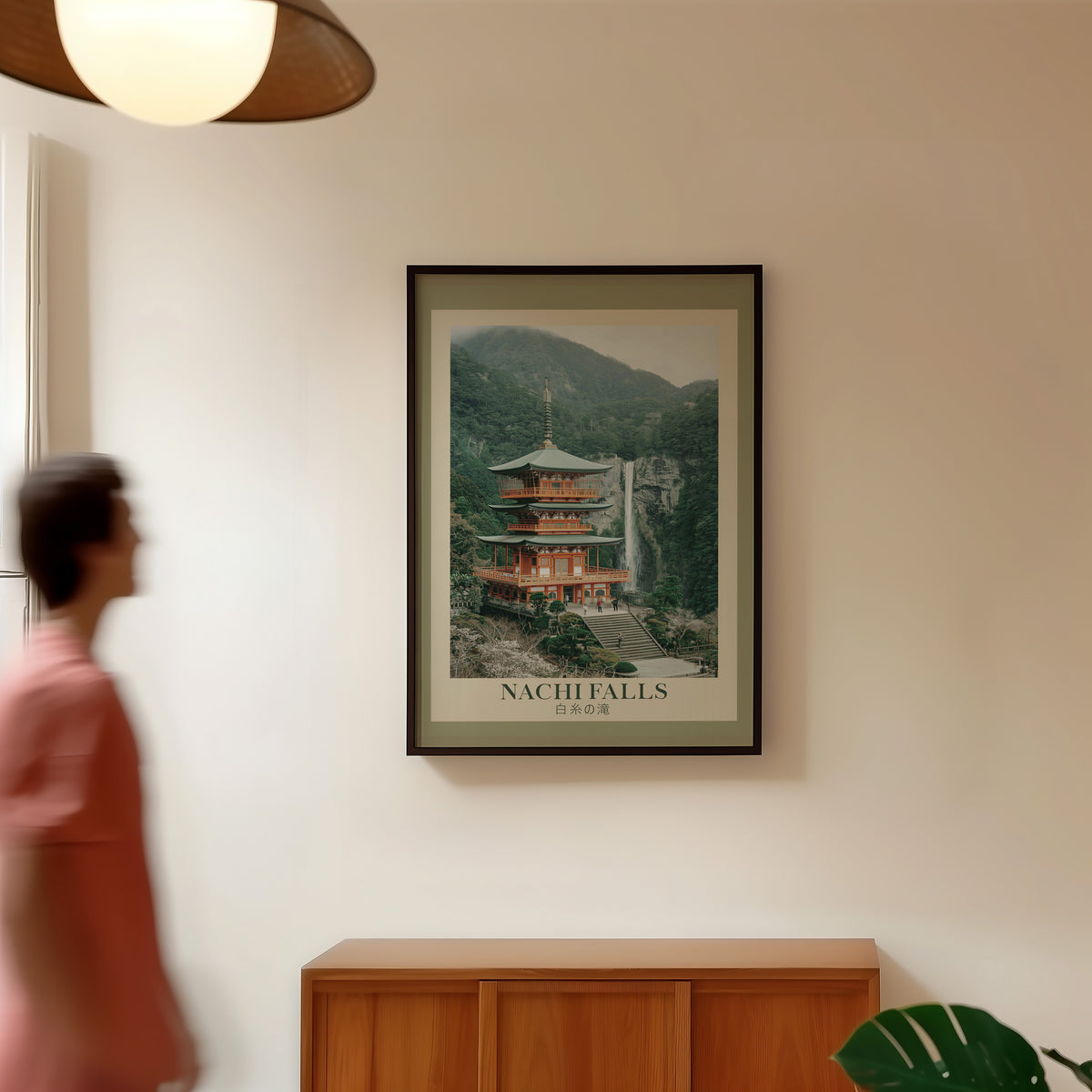 Nachi Falls and red pagoda print in a black frame in a hallway under a rattan pendant