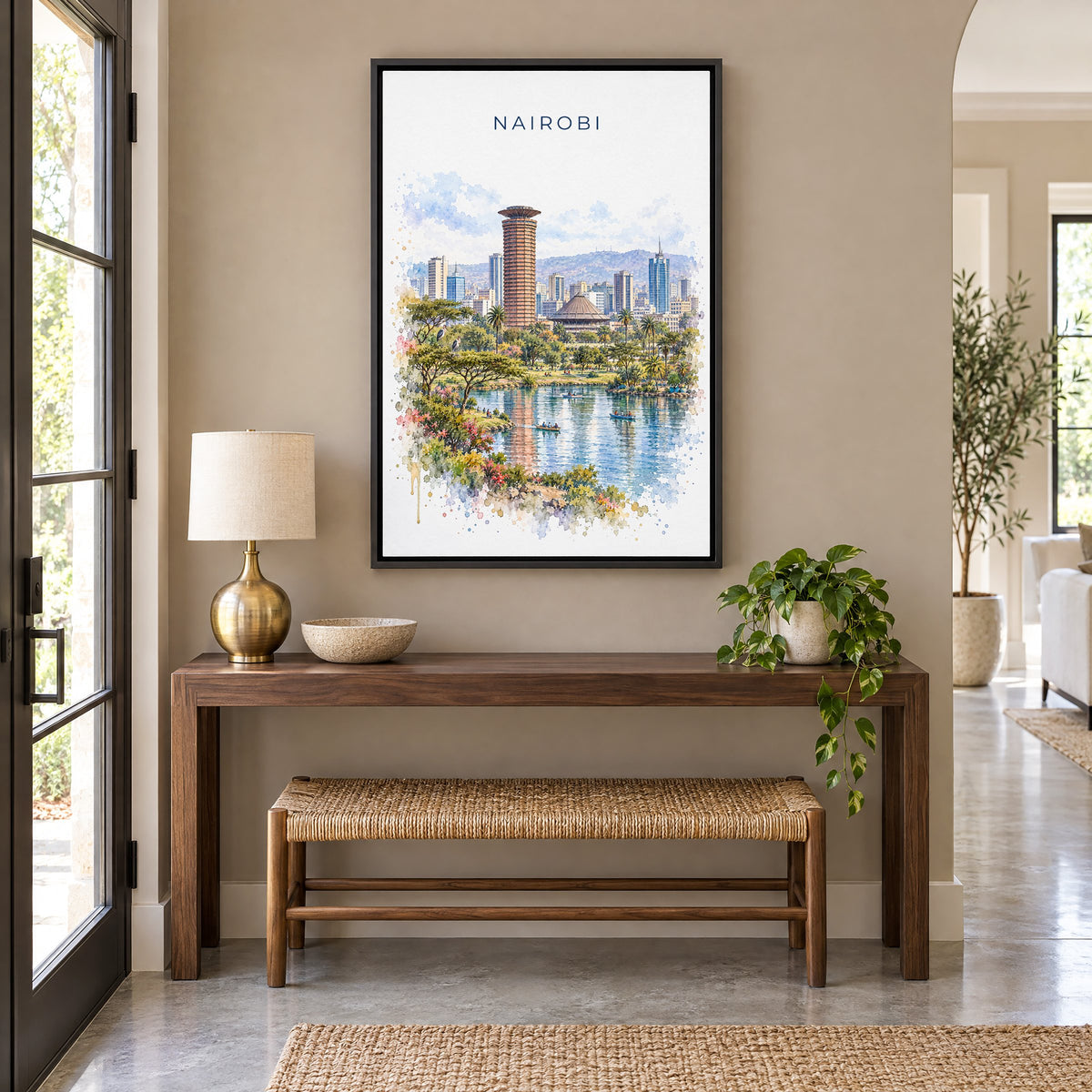 Nairobi watercolor print as a black floater canvas above a walnut console and woven bench in an entryway