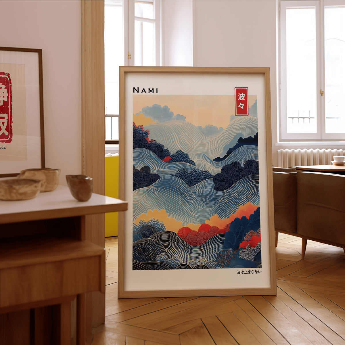 Blue layered Nami wave print in an oak frame on the parquet floor of a sunlit living room