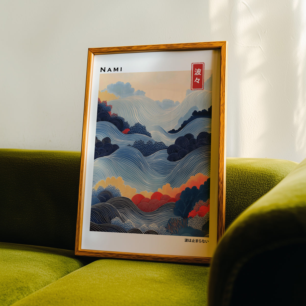 Blue layered Nami wave print in an oak frame propped on a green velvet sofa