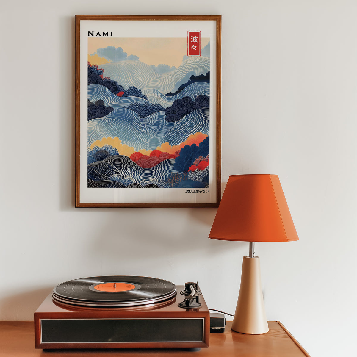 Blue layered Nami wave print in a walnut frame above a sideboard with a record player