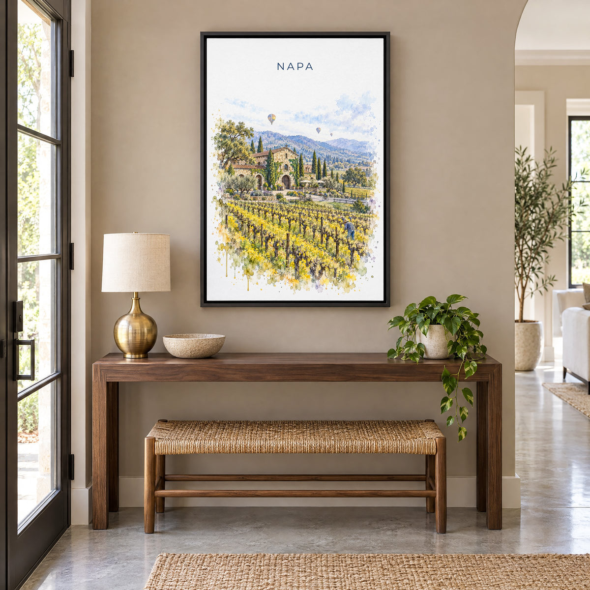 Napa watercolor print as a black floater canvas above a walnut console and woven bench in an entryway