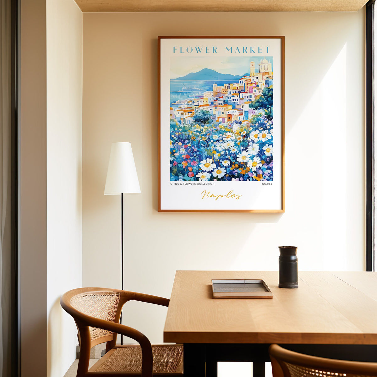 Naples flower market print in an oak frame above a dining table and cane chair