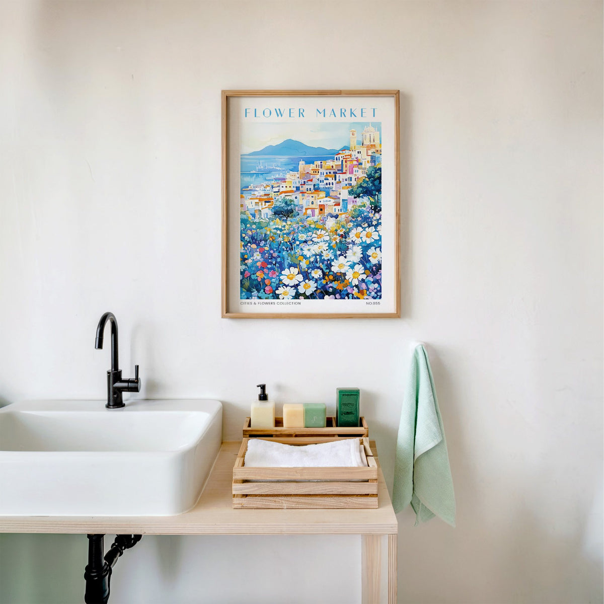 Naples flower market print in an oak frame above a white bathroom sink with folded towels