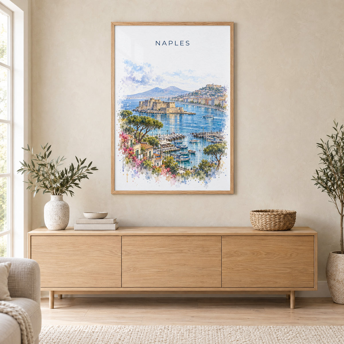 Naples, Italy watercolor print in an oak frame above a light wood sideboard in a Scandinavian living room