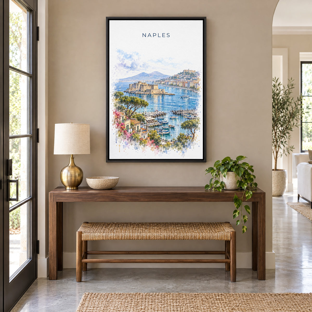 Naples, Italy watercolor print as a black floater canvas above a walnut console and woven bench in an entryway