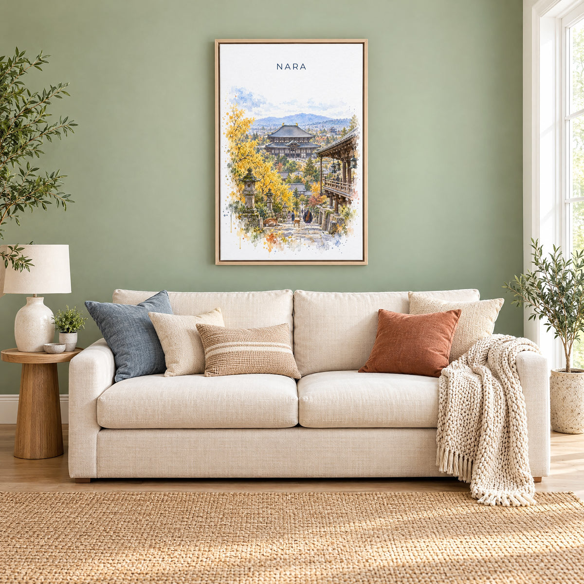 Nara watercolor print as a natural floater canvas above a cream linen sofa on a sage green wall