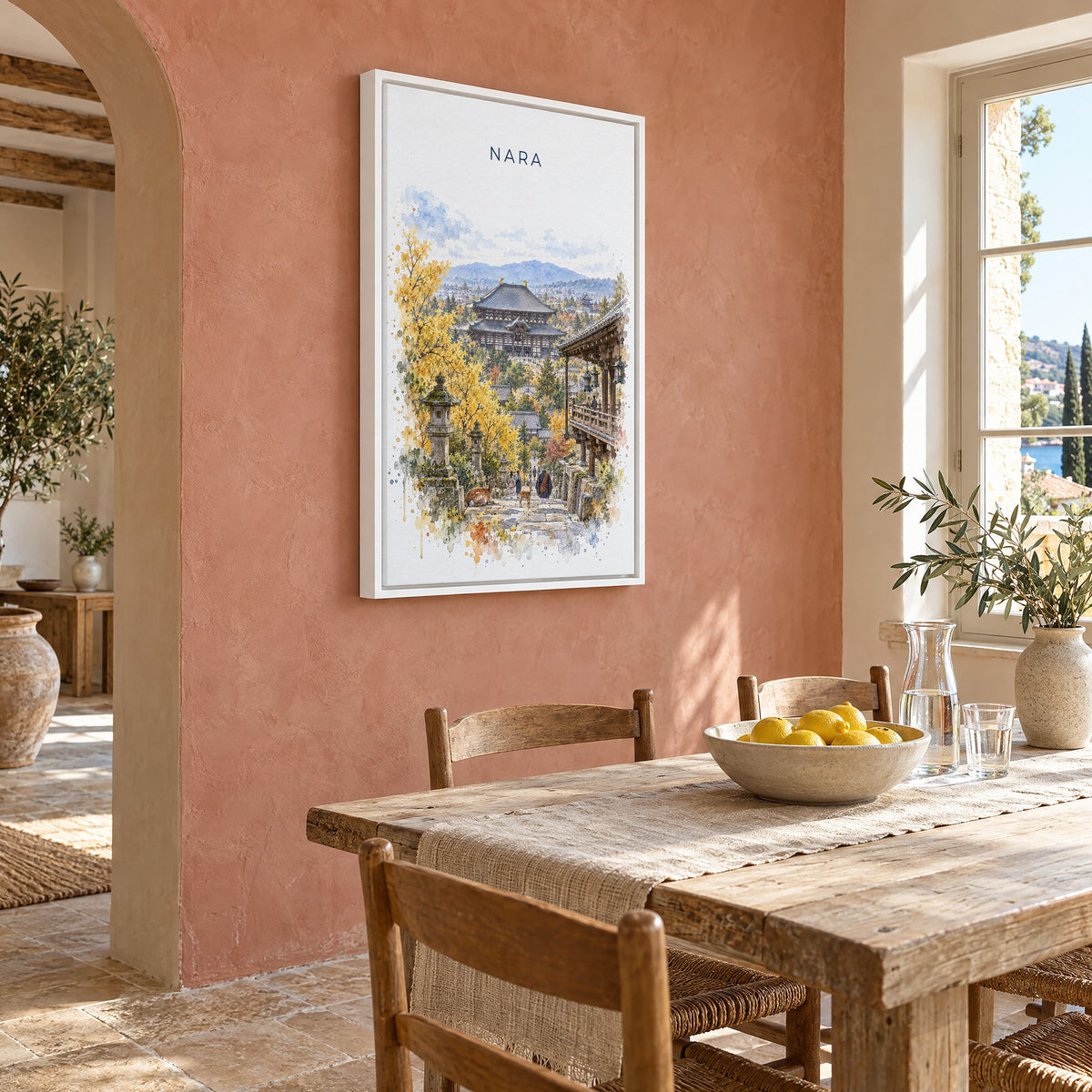 Nara watercolor print as a white floater canvas on a terracotta wall above a rustic dining table