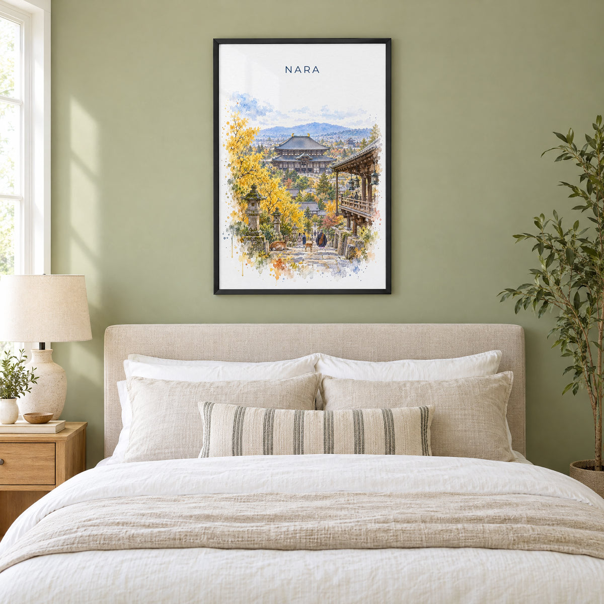 Nara watercolor print in a black frame above an upholstered headboard in a sage green bedroom