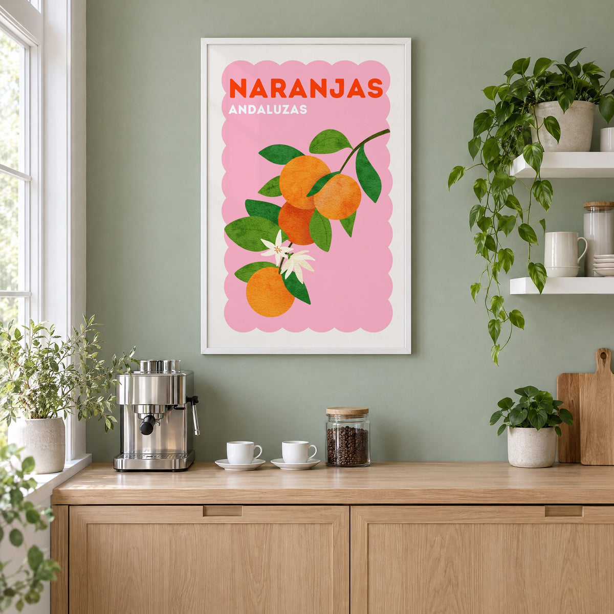 Naranjas Andaluzas orange branch print in a white frame on a sage green coffee nook wall above an espresso machine