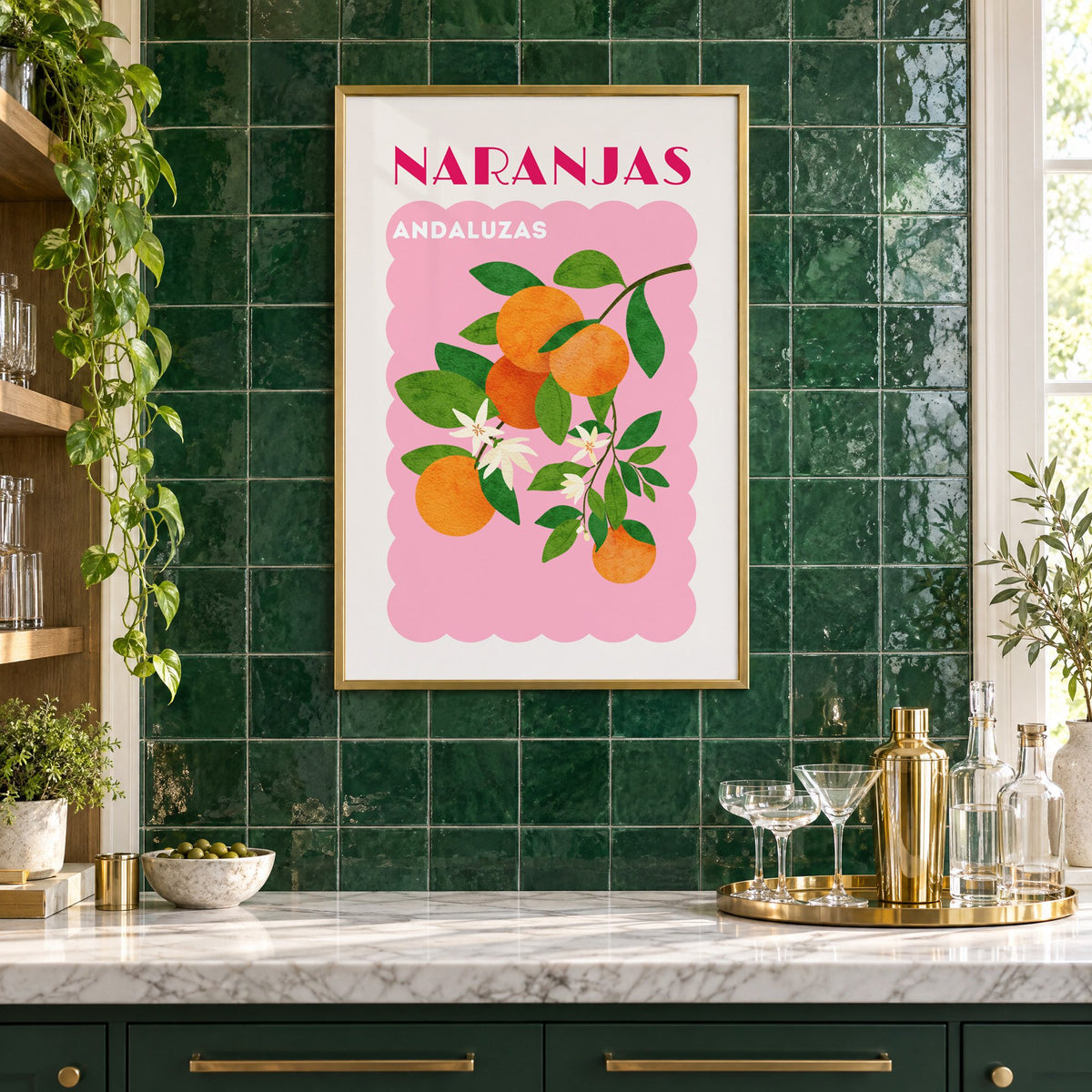 NARANJAS ANDALUZAS orange branch print in a brass frame on emerald green tiles above a home bar with coupe glasses