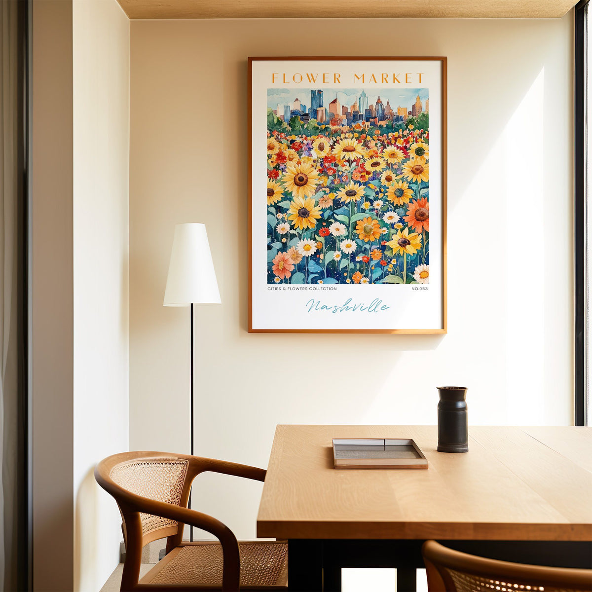 Nashville flower market print in an oak frame above a dining table and cane chair