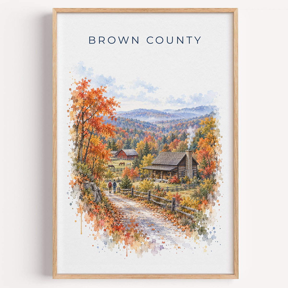 Nashville, Indiana watercolor print in a light oak frame on a plain white wall