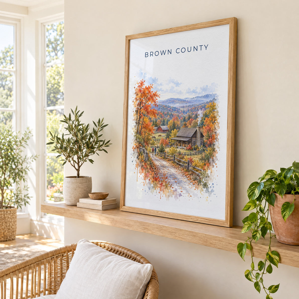 Nashville, Indiana watercolor print in an oak frame on a picture ledge in a sunlit sunroom