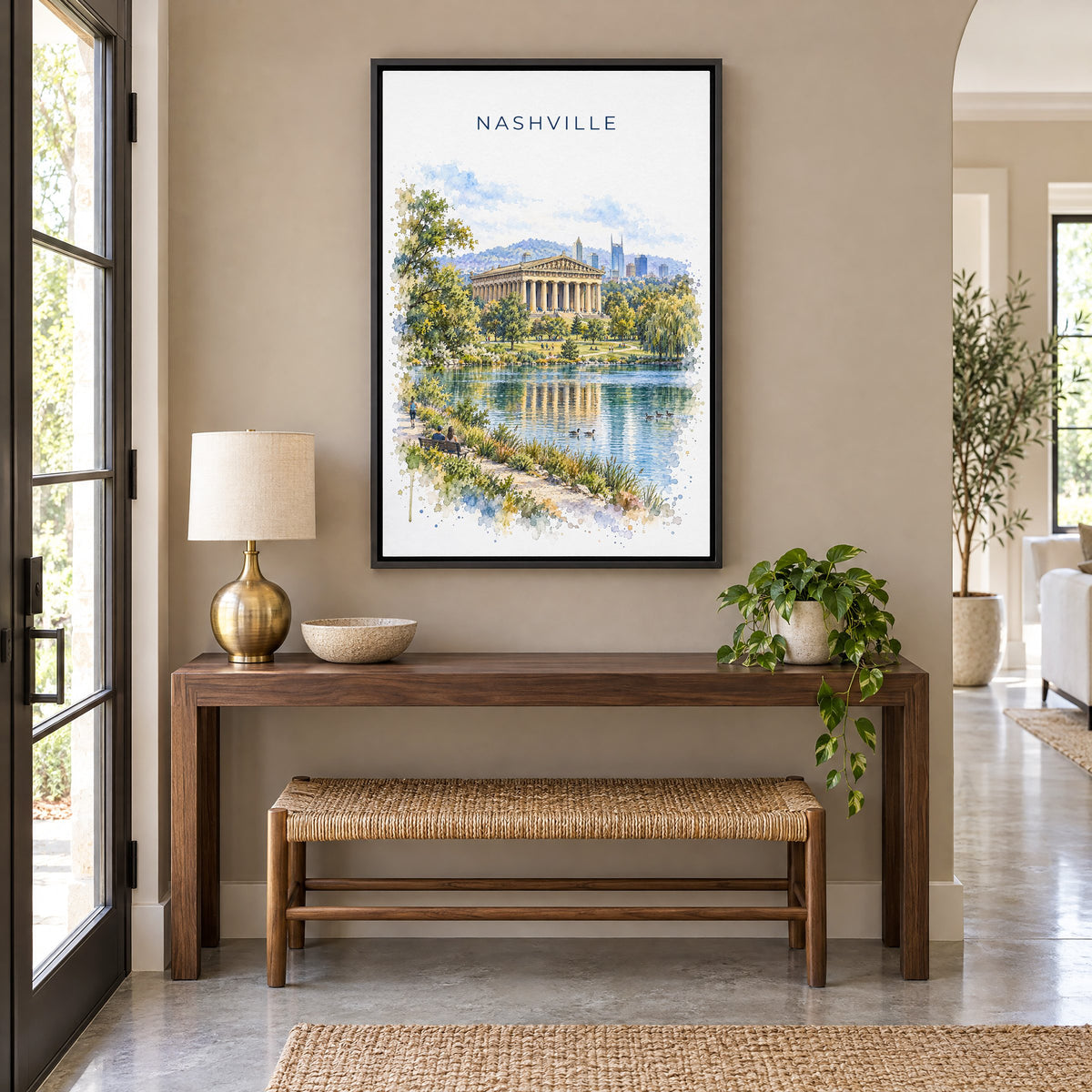 Nashville Parthenon watercolor print as a black floater canvas above a walnut console and woven bench in an entryway