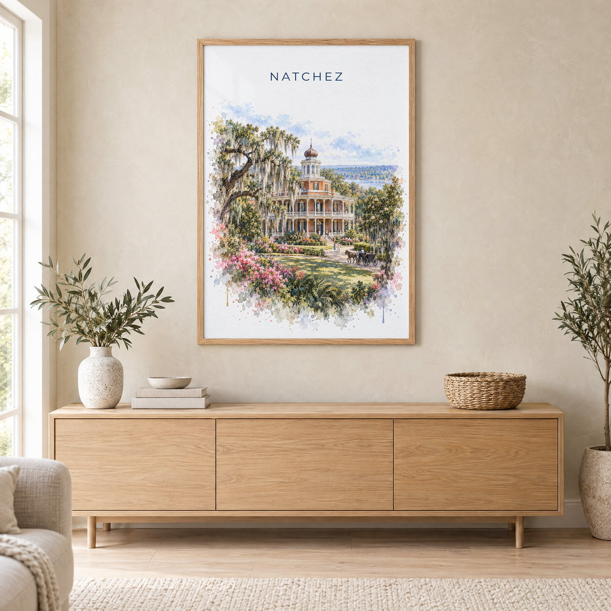 Natchez watercolor print in an oak frame above a light wood sideboard in a Scandinavian living room