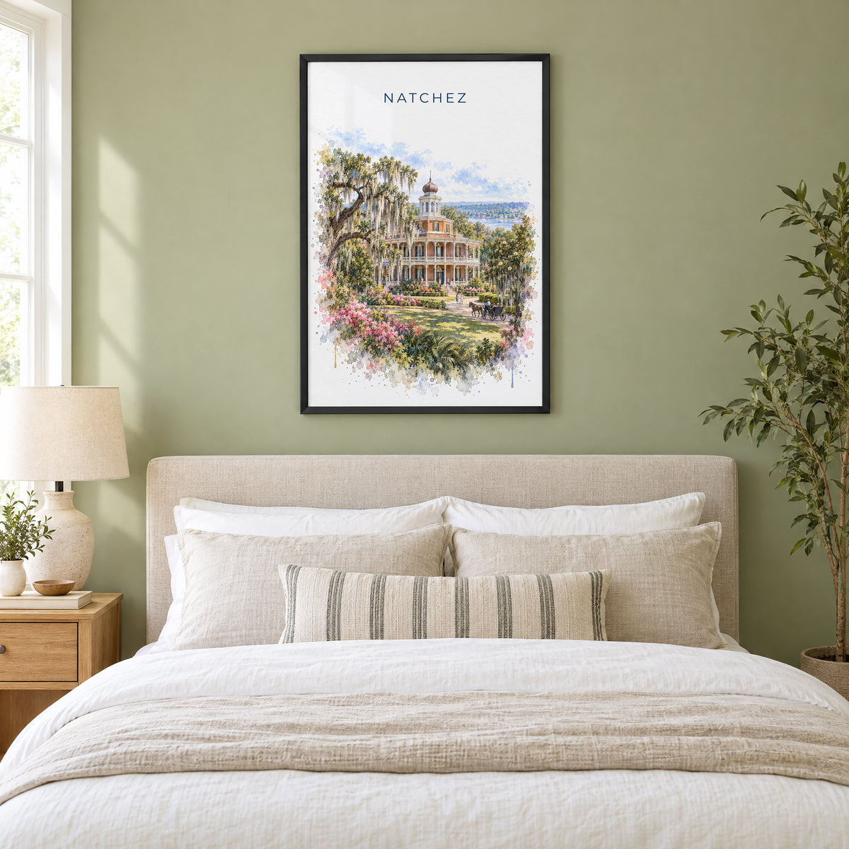 Natchez watercolor print in a black frame above an upholstered headboard in a sage green bedroom