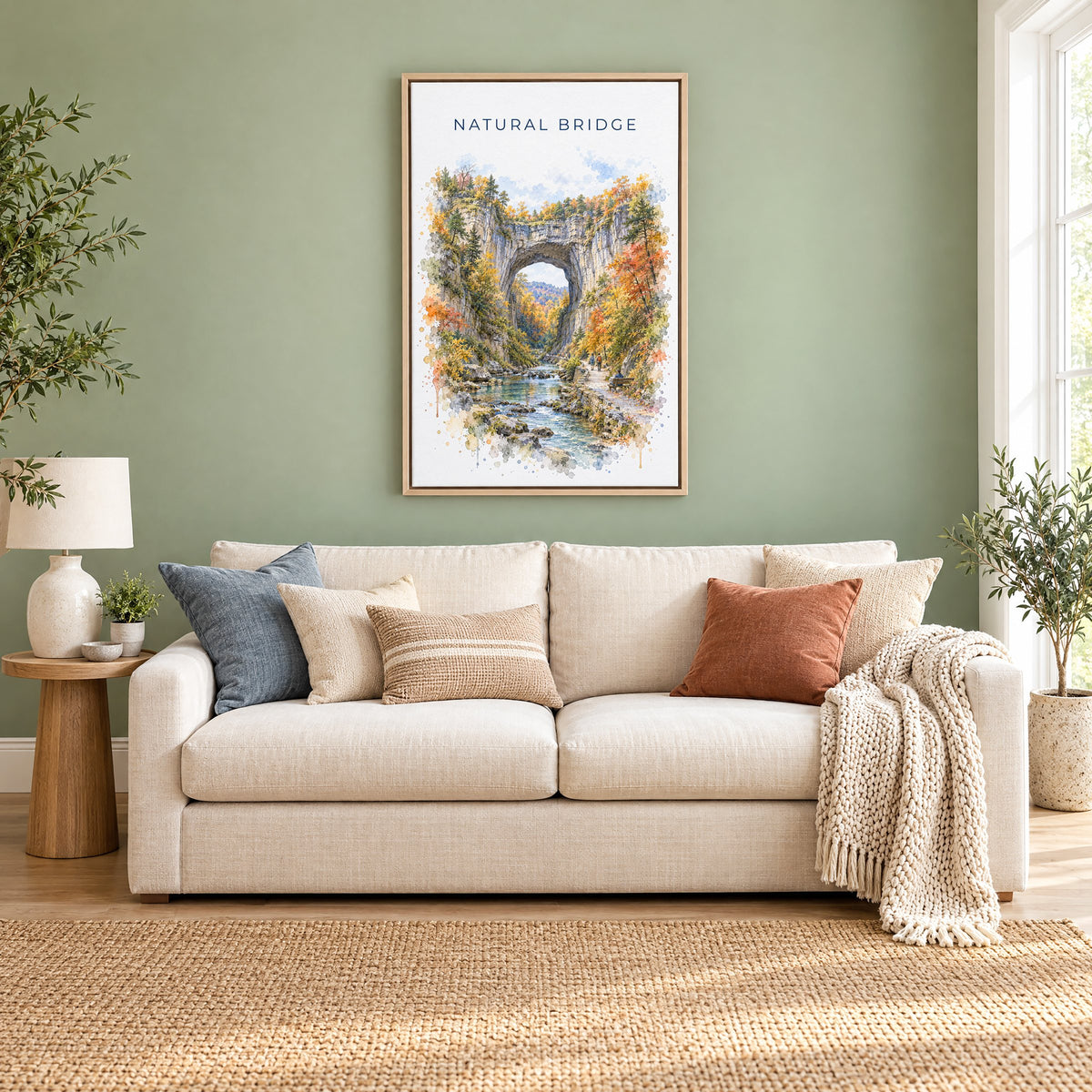 Natural Bridge, Virginia watercolor print as a natural floater canvas above a cream linen sofa on a sage green wall