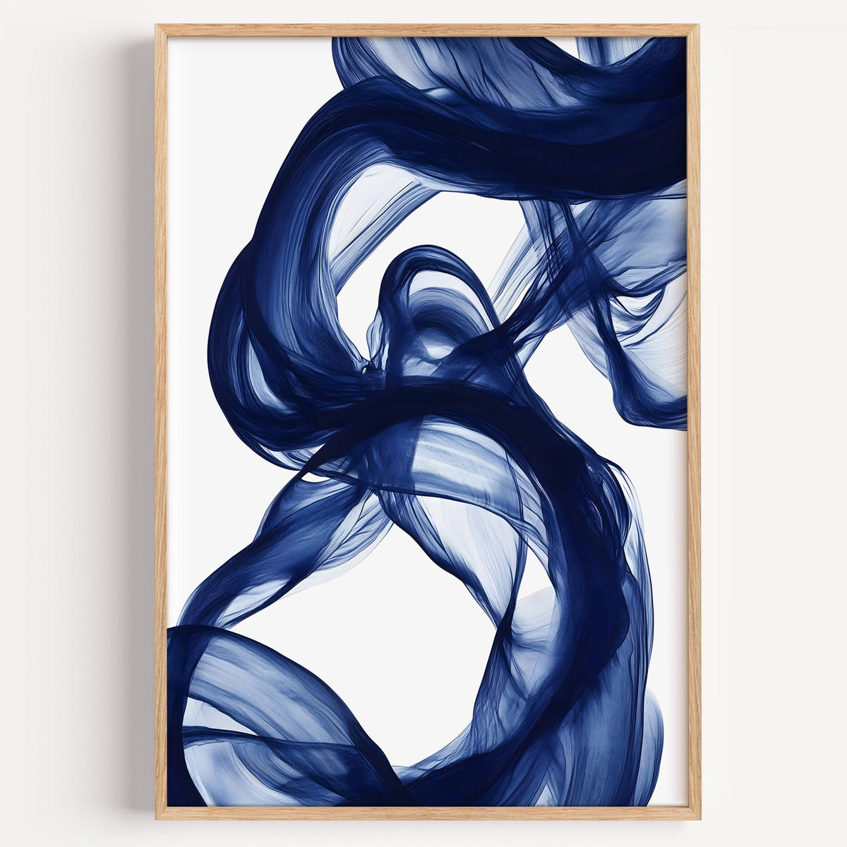 Navy blue silk swirl fluid abstract print in a light oak frame on a plain white wall