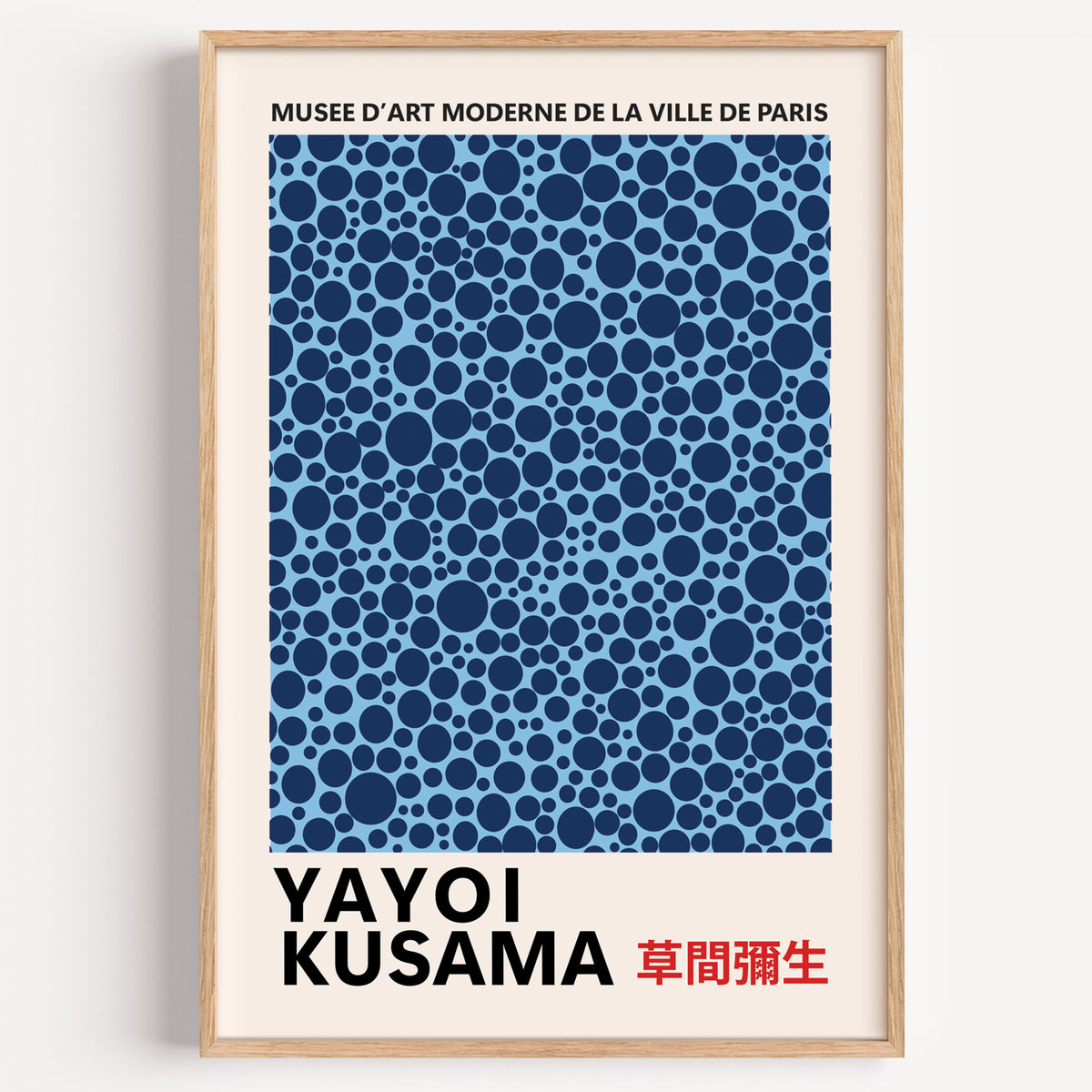 Yayoi Kusama inspired navy polka dot pattern print in a wood frame on a plain wall