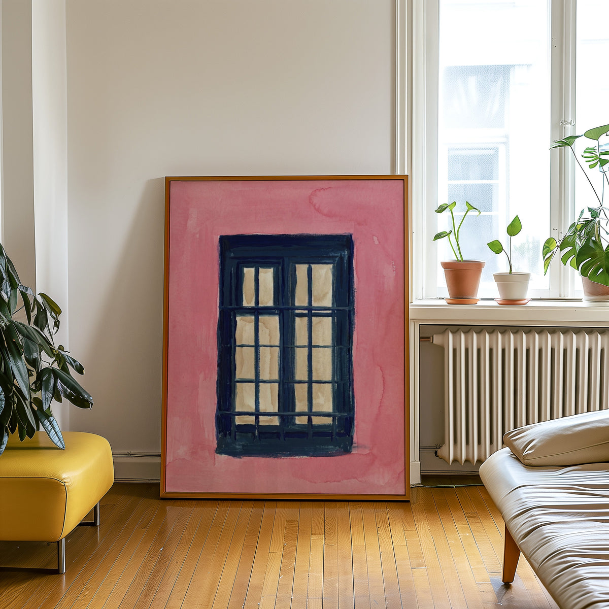 Coral and navy window print in an oak frame leaning beside a yellow leather bench