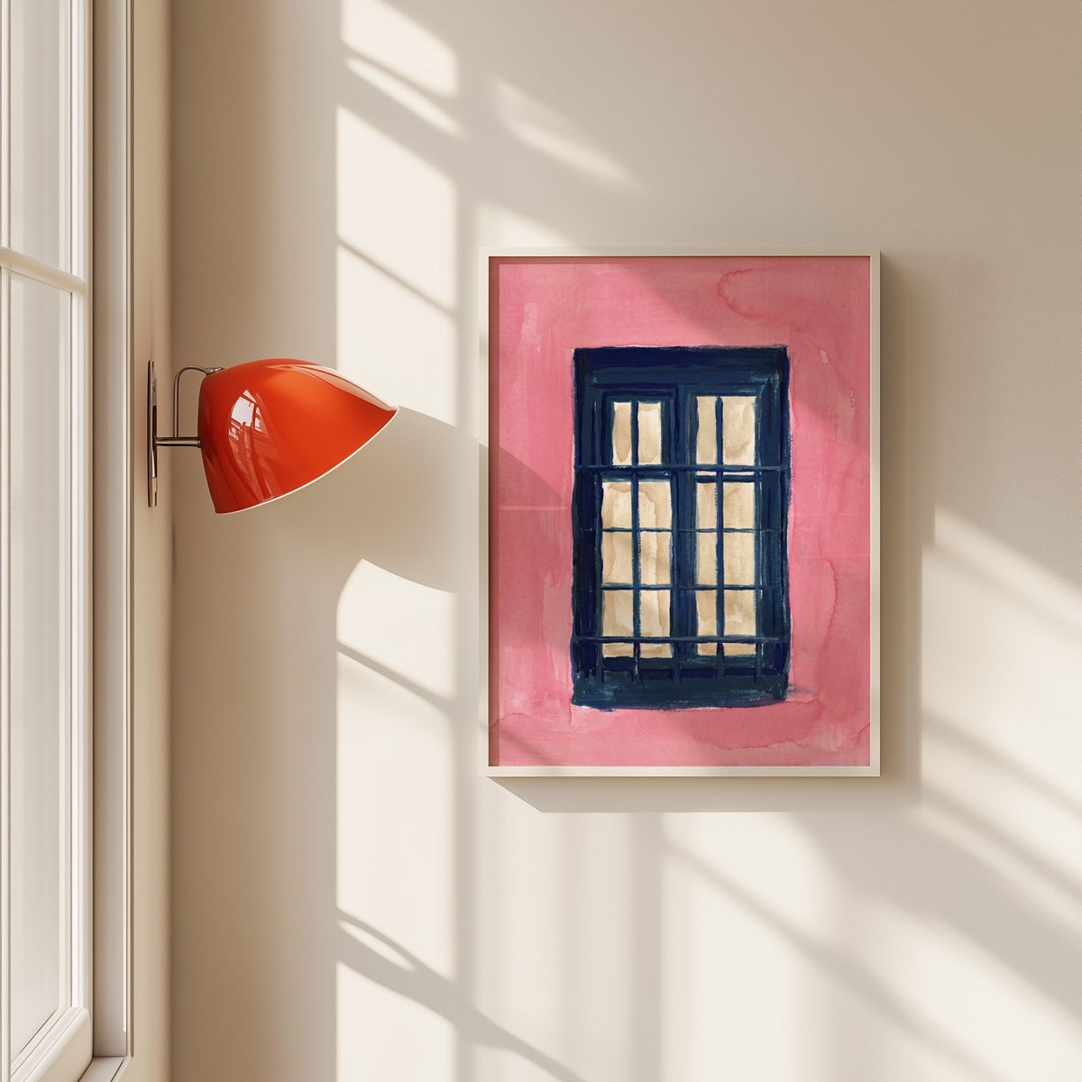 Navy window on pink wall print in a white frame beside a red wall sconce