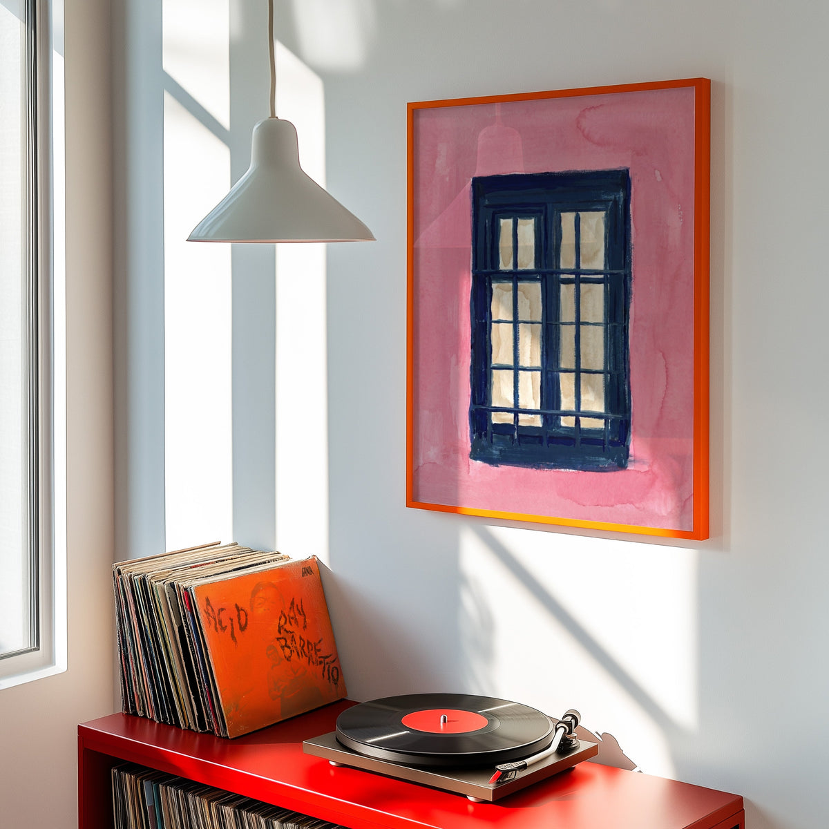 Pink wall window print shown in an orange frame above a red record cabinet and turntable
