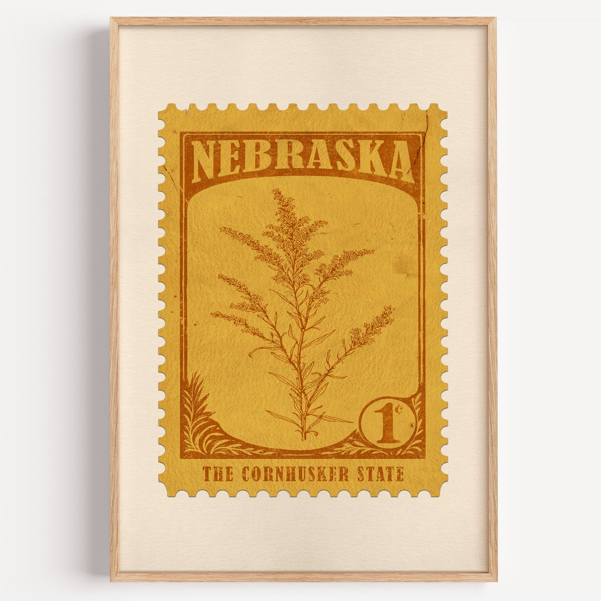 Nebraska state flower stamp print in ochre brown on mustard, light oak frame on a plain white wall