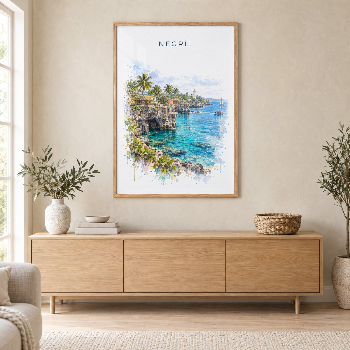 Negril watercolor print in an oak frame above a light wood sideboard in a Scandinavian living room
