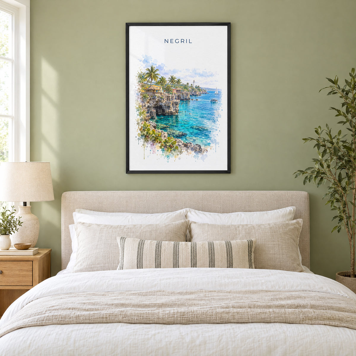 Negril watercolor print in a black frame above an upholstered headboard in a sage green bedroom
