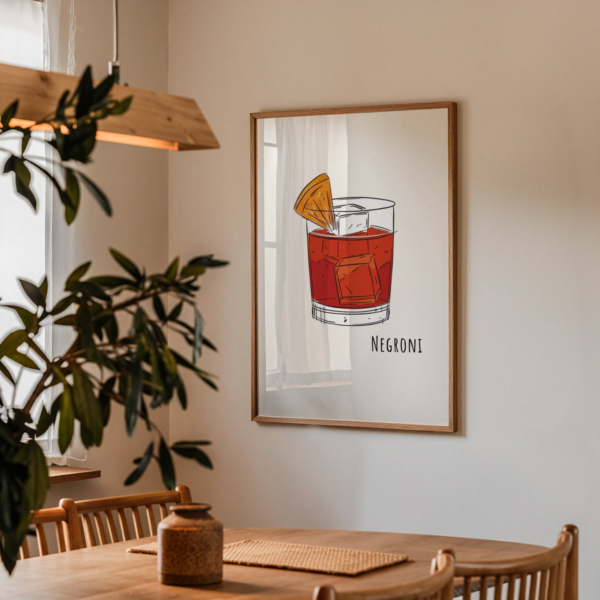 Negroni line print in a walnut frame above a dining table with olive branches
