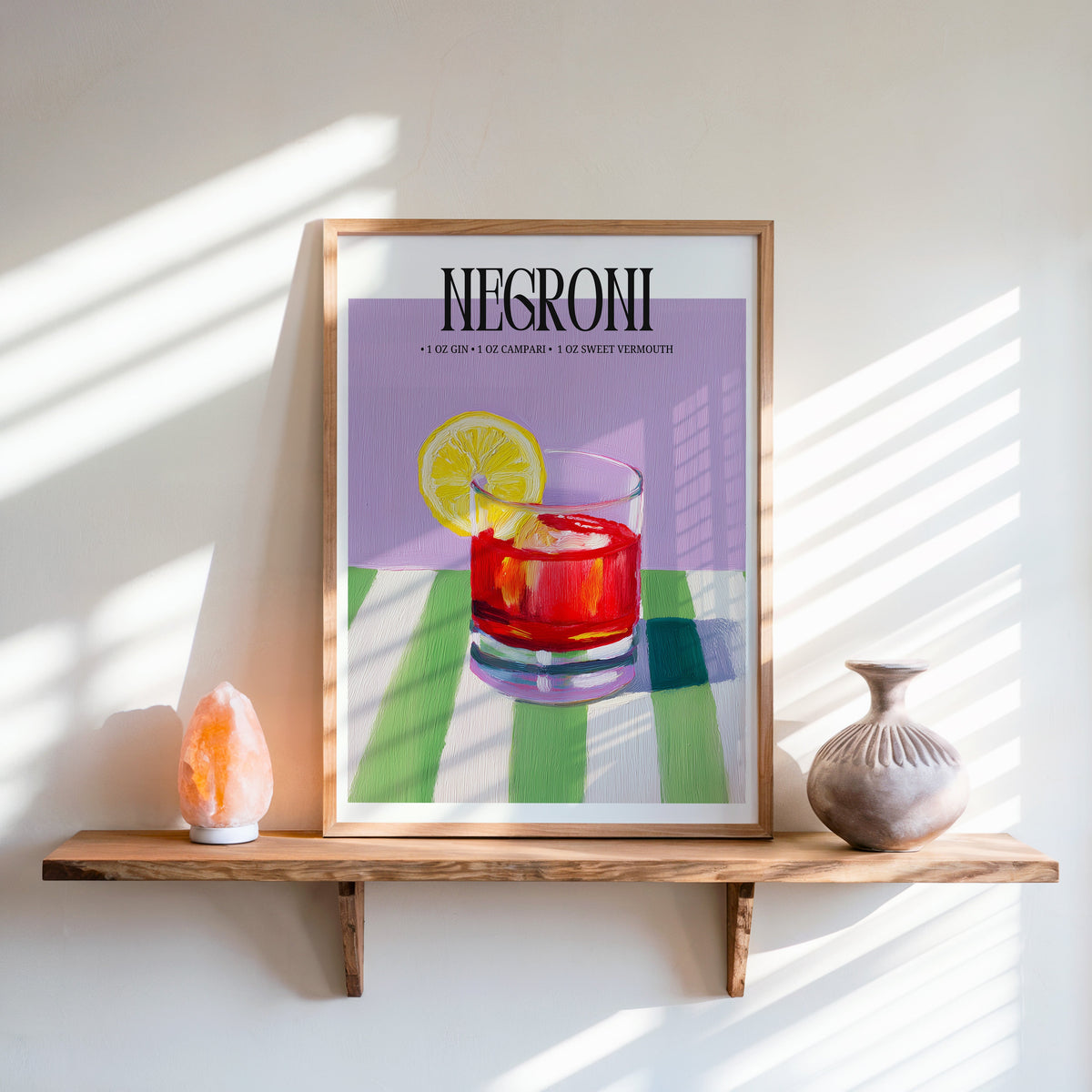 Negroni painterly print in an oak frame on a live-edge shelf beside a salt lamp