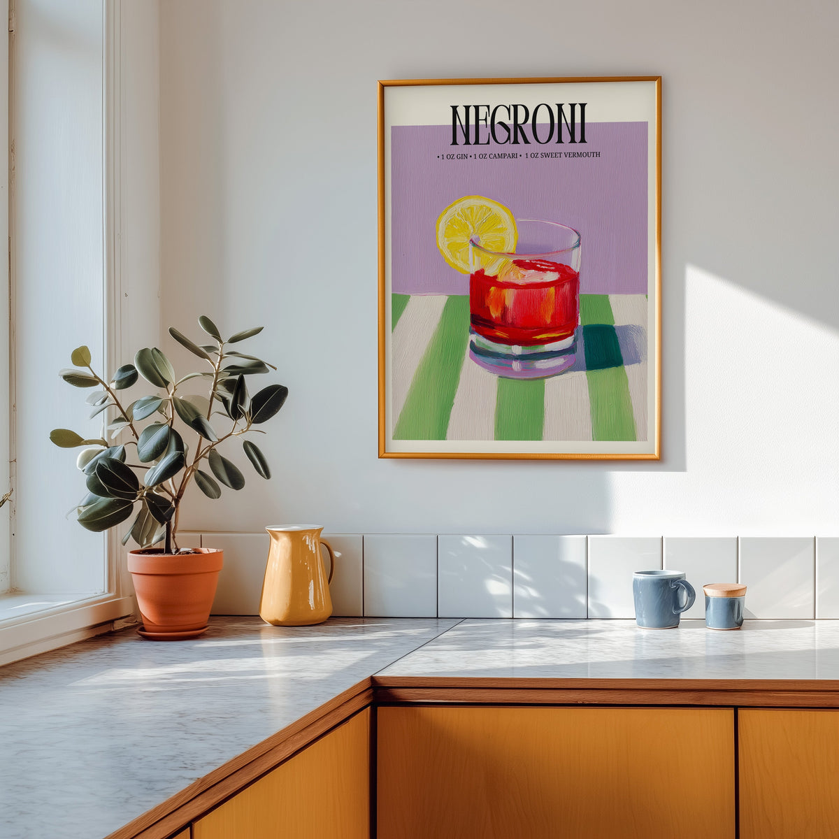Negroni painterly print shown in a gold frame above a marble counter in a tan kitchen