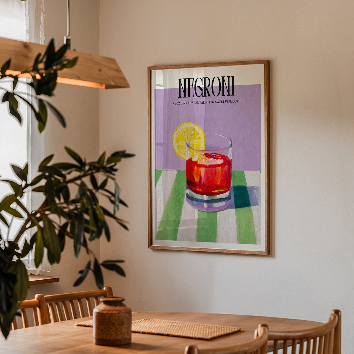 Negroni painterly print in a walnut frame above a dining table with olive branches