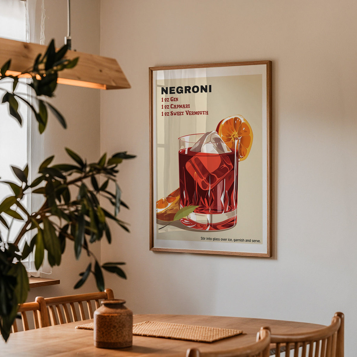 Negroni recipe print in a walnut frame above a dining table with olive branches