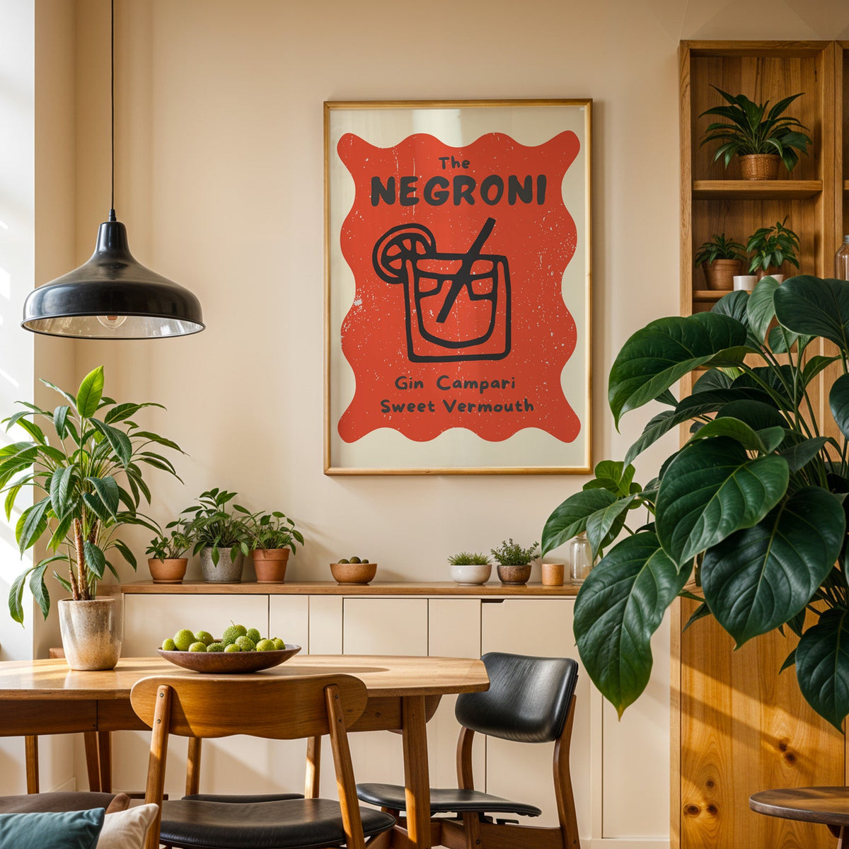 Negroni print in an oak frame in a dining room above a plant-lined sideboard