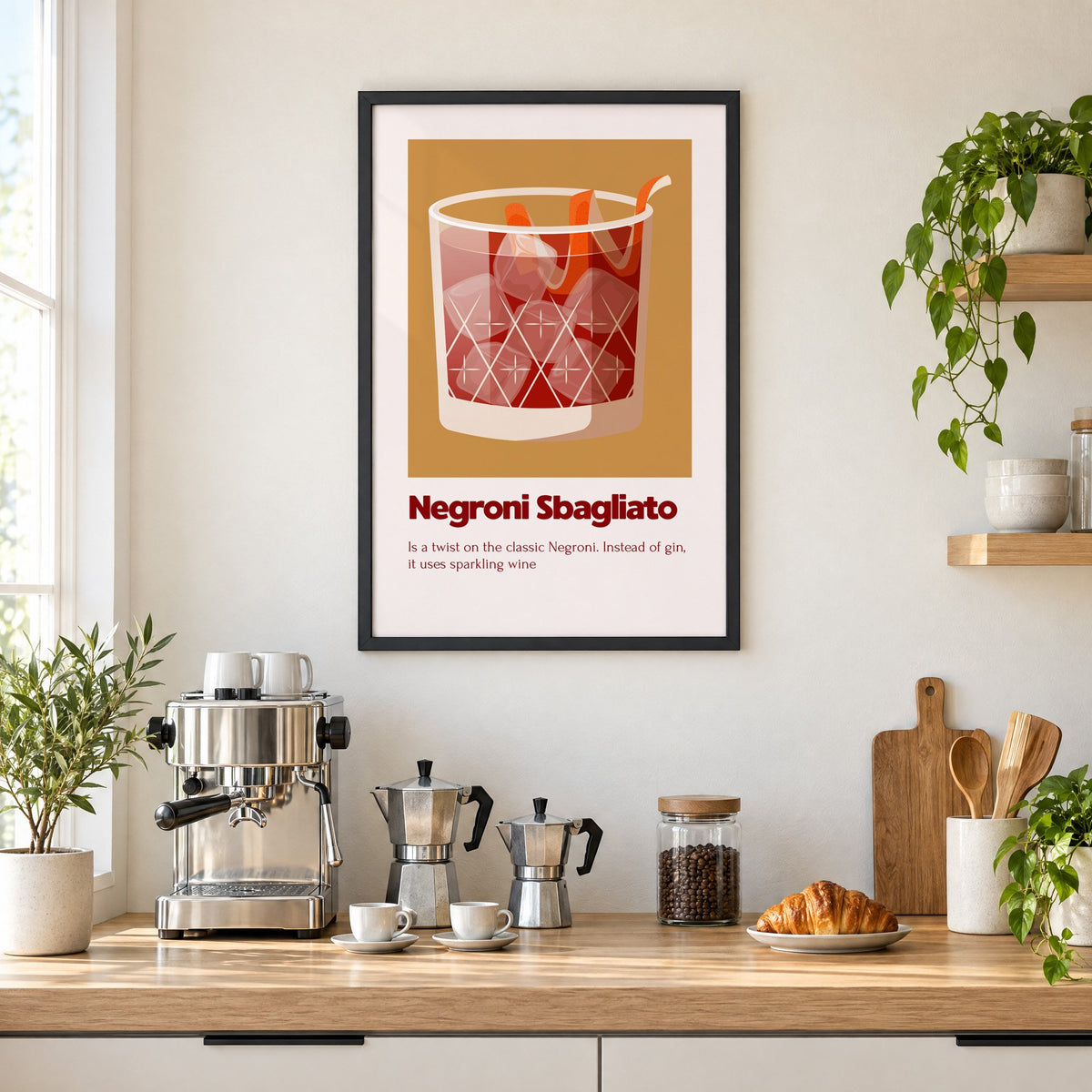 Negroni Sbagliato rocks glass ochre card print in a black frame above a home espresso bar with moka pots and espresso cups