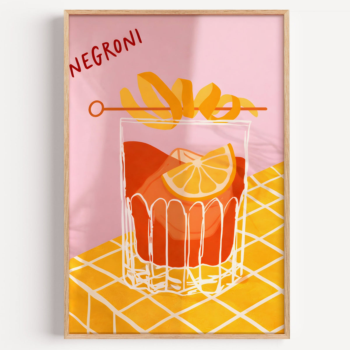 Negroni cocktail print in a light oak frame on a plain white wall