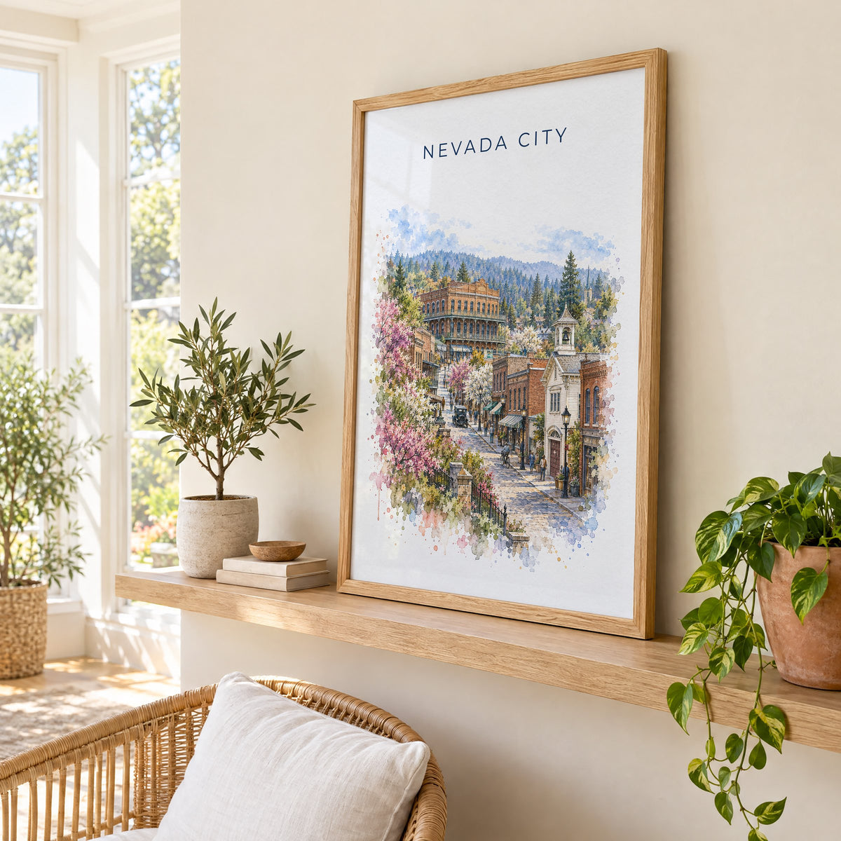 Nevada City, California watercolor print in an oak frame on a picture ledge in a sunlit sunroom