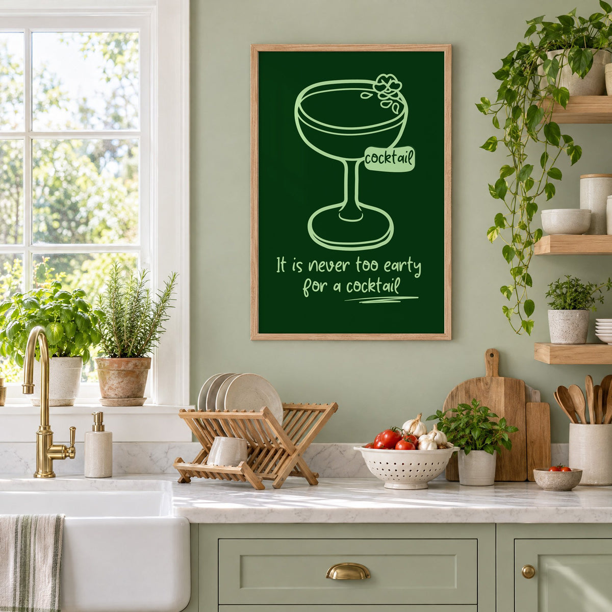 Never too early cocktail coupe print in an oak frame on a sage green kitchen wall beside a farmhouse sink and herbs