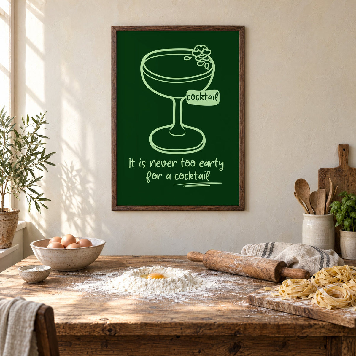 Never too early cocktail coupe print in a walnut frame above a rustic table set for making fresh pasta