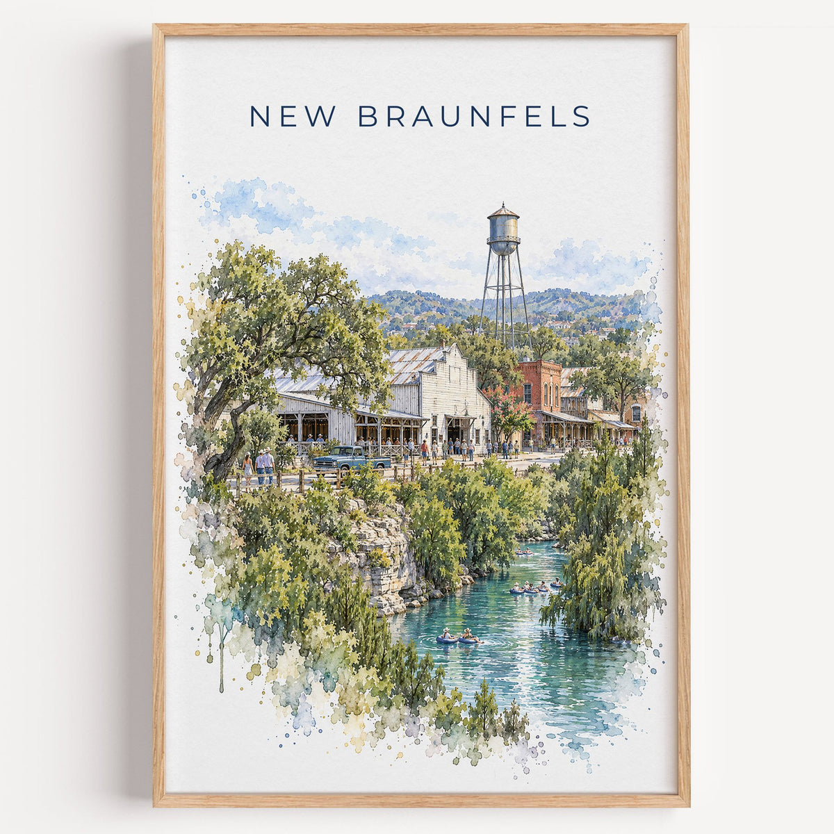 New Braunfels watercolor print in a light oak frame on a plain white wall