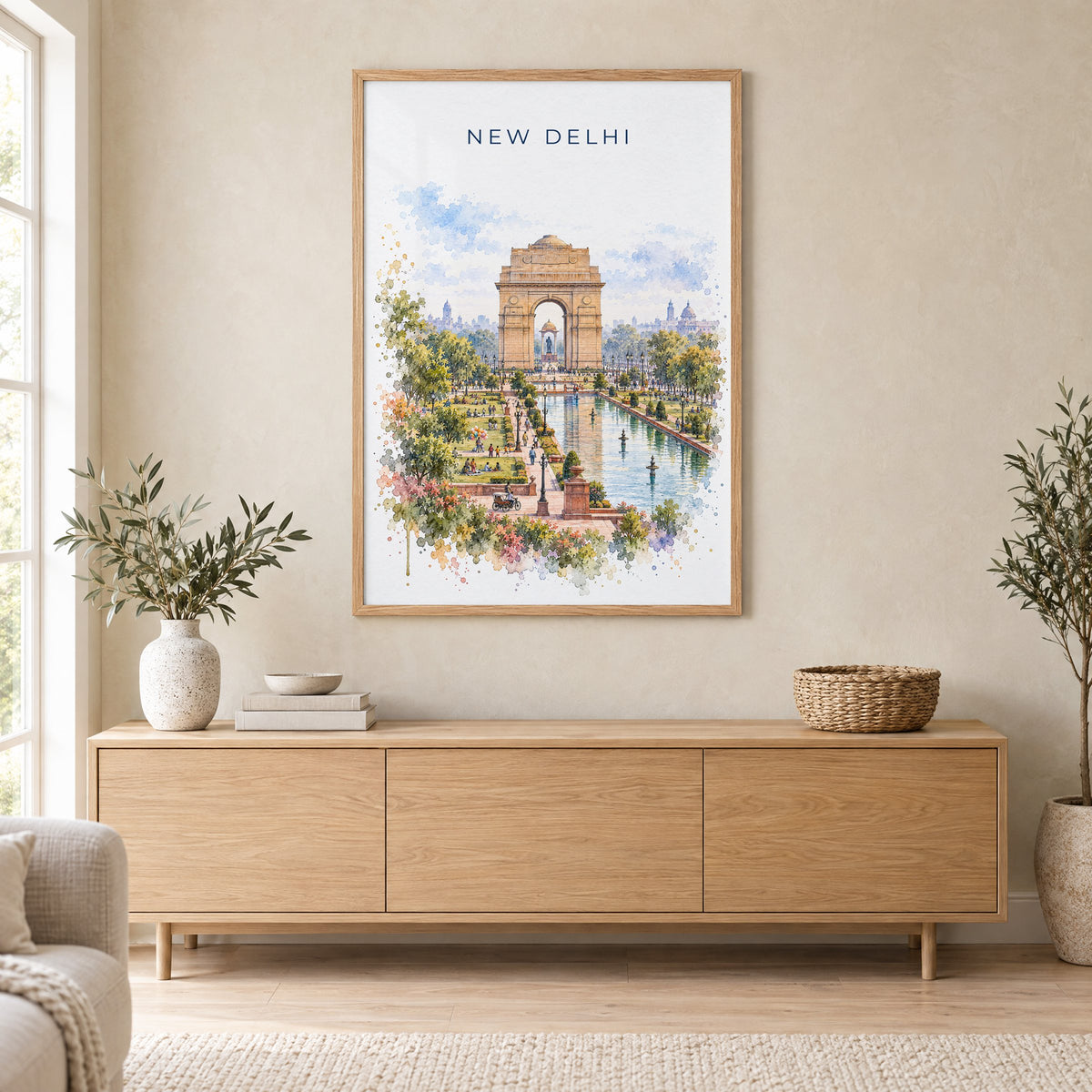 New Delhi watercolor print in an oak frame above a light wood sideboard in a Scandinavian living room