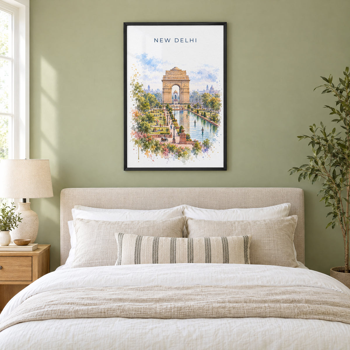 New Delhi watercolor print in a black frame above an upholstered headboard in a sage green bedroom