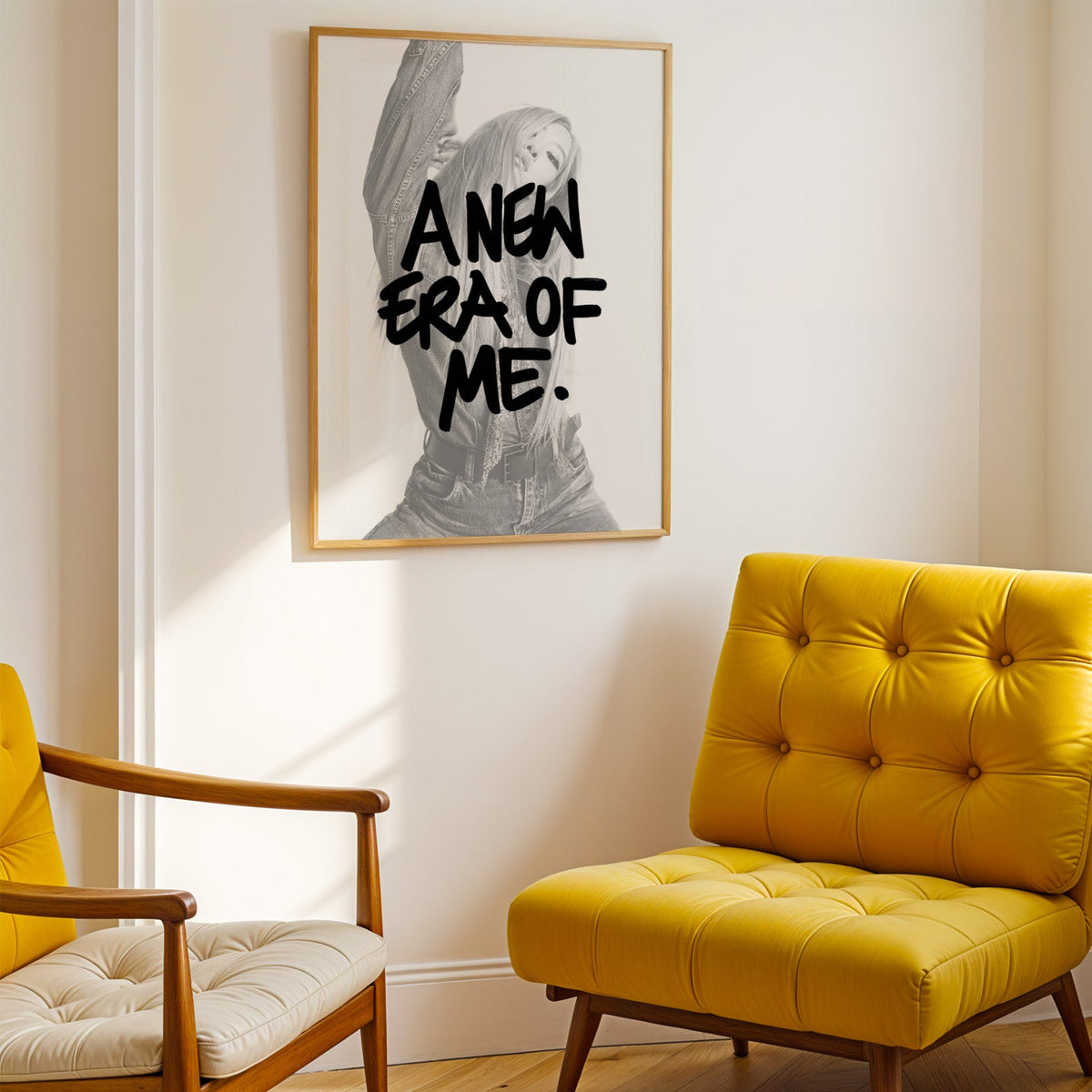 A new era of me lettering over woman in denim print shown in a gold frame above a mustard yellow tufted armchair