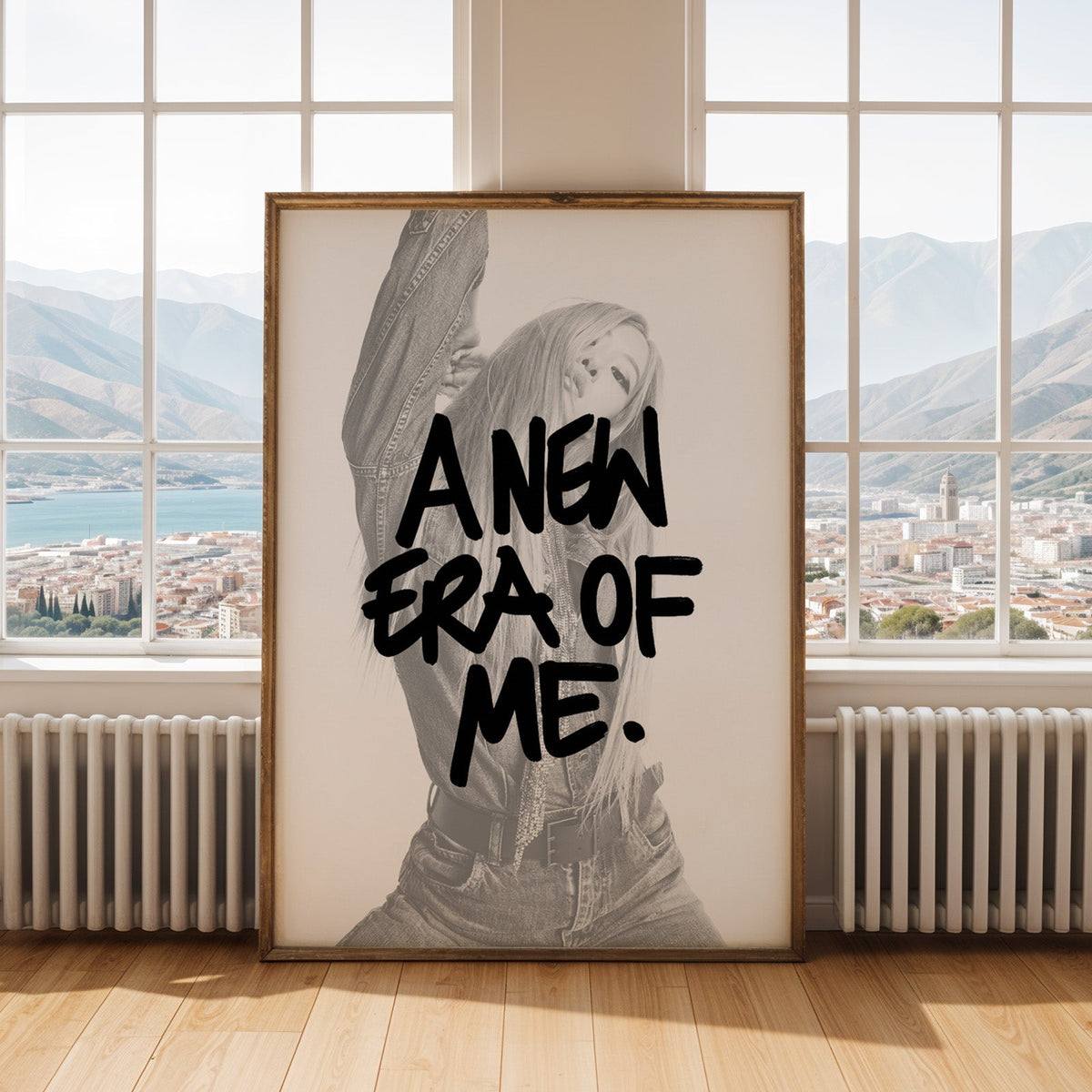 A new era of me lettering over woman in denim print shown in an antique gold frame by tall windows with a sea view