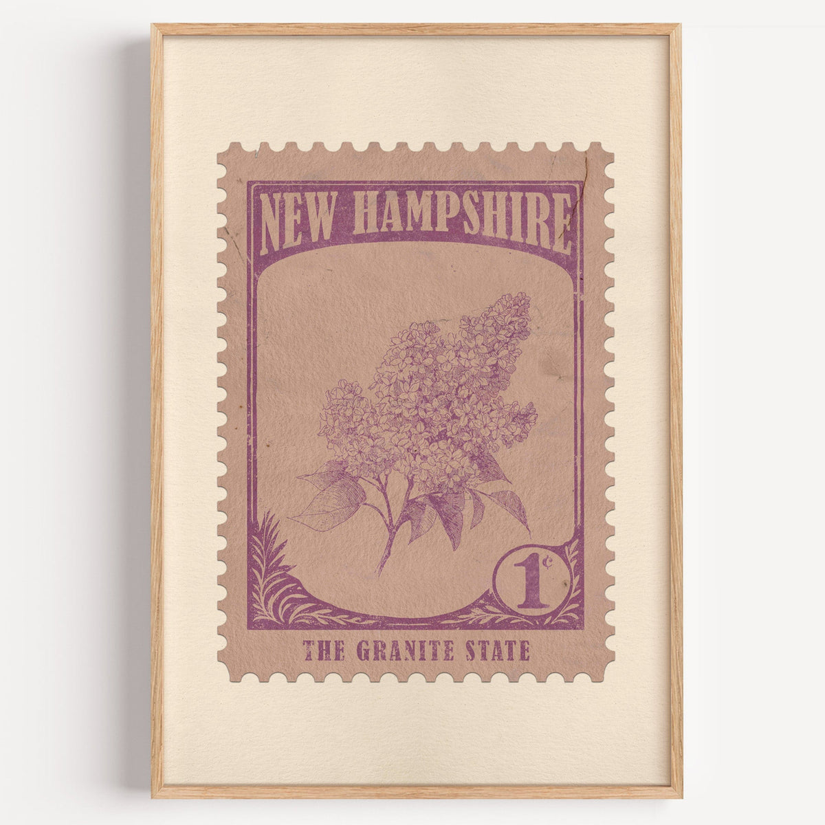 New Hampshire state flower stamp print in mauve purple on rose tan, light oak frame on a plain white wall