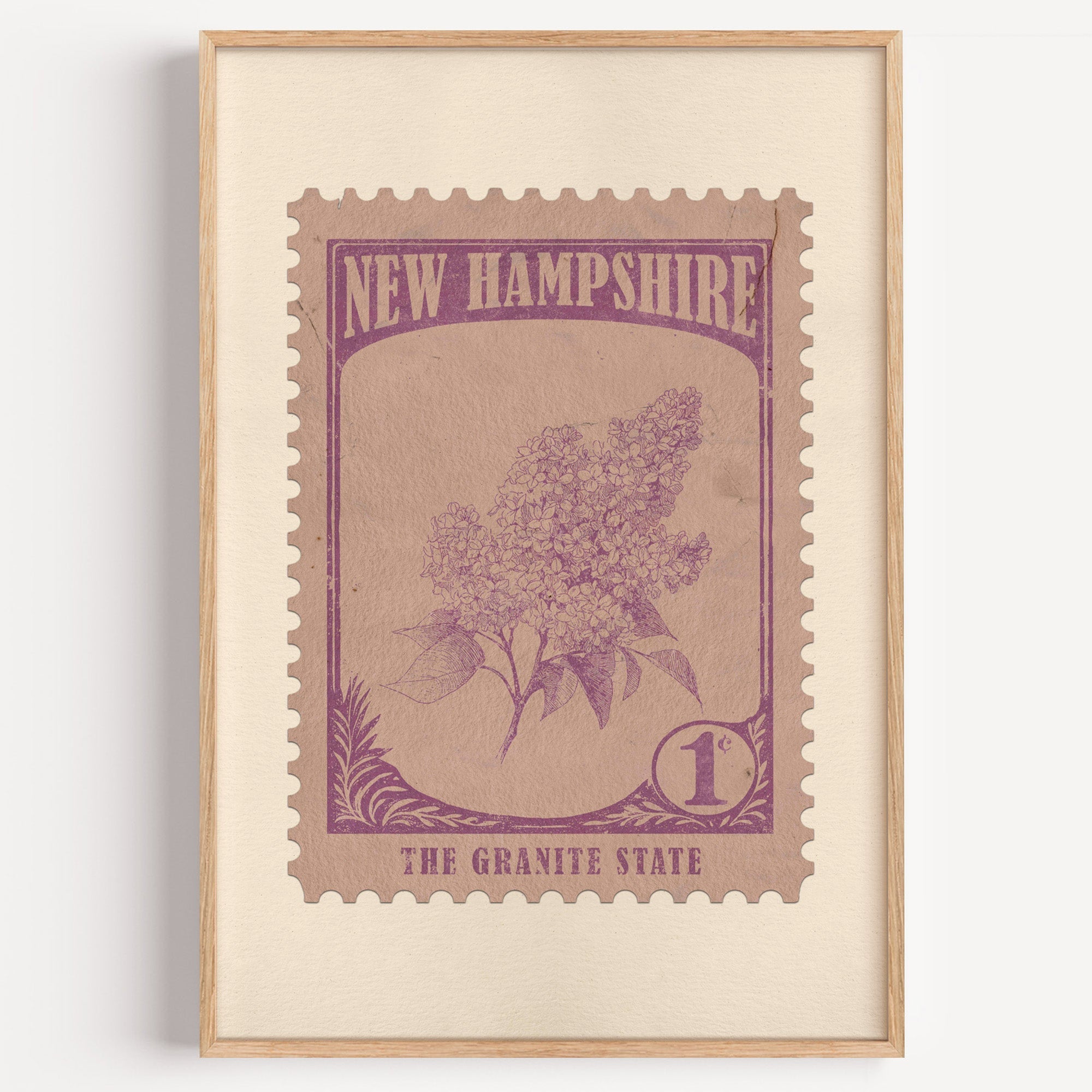New Hampshire state flower stamp print in mauve purple on rose tan, light oak frame on a plain white wall