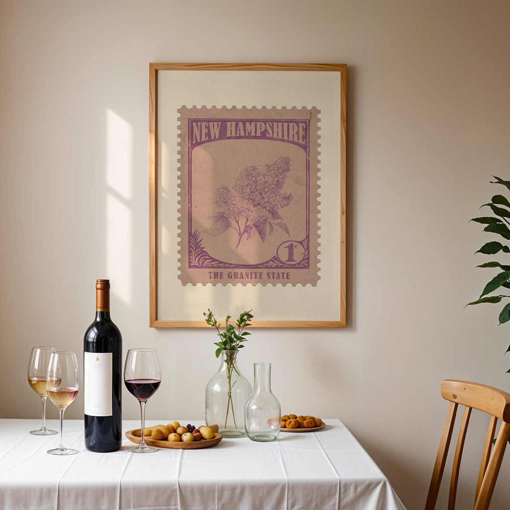 New Hampshire stamp print framed on the wall above a dining table set with wine, glasses and olives