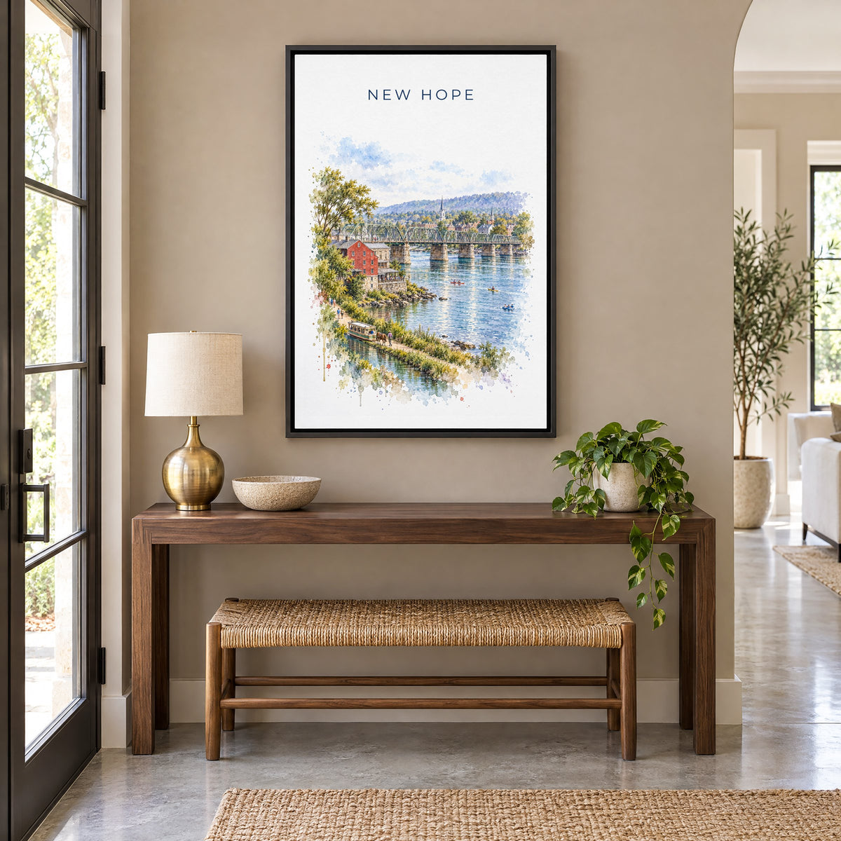 New Hope, Pennsylvania watercolor print as a black floater canvas above a walnut console and woven bench in an entryway